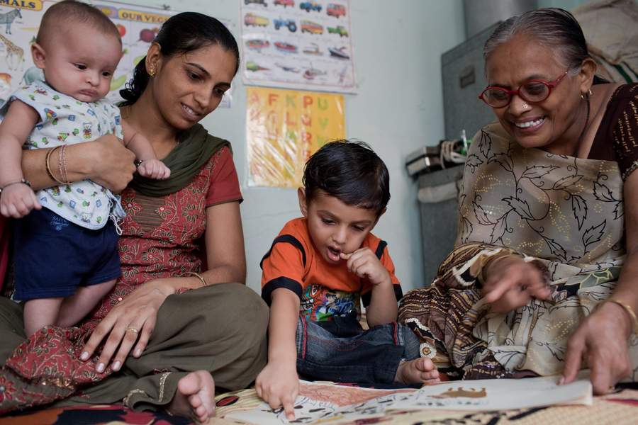 Young women learning together around a table in India