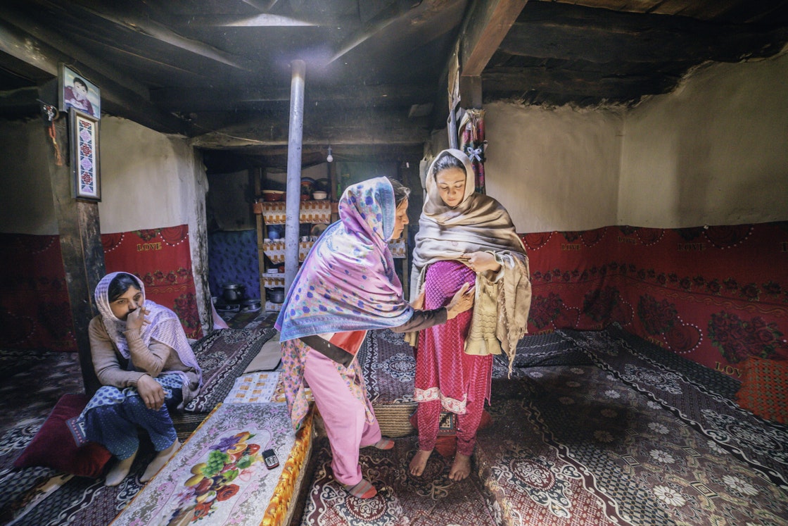 A dai (lady health worker) in Chipurson Valley, Pakistan carries out a routine check-up with a pregnant woman from a nearby village.