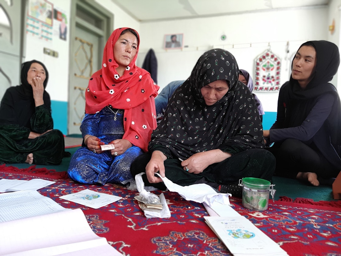 “Now our roles have changed, and it is more equal to that of men. We feel a part of the household now,” says Benazir (front centre), the accountant of Hamisha Bahar community-based savings group. AKDN / Conrad Koczorowski
