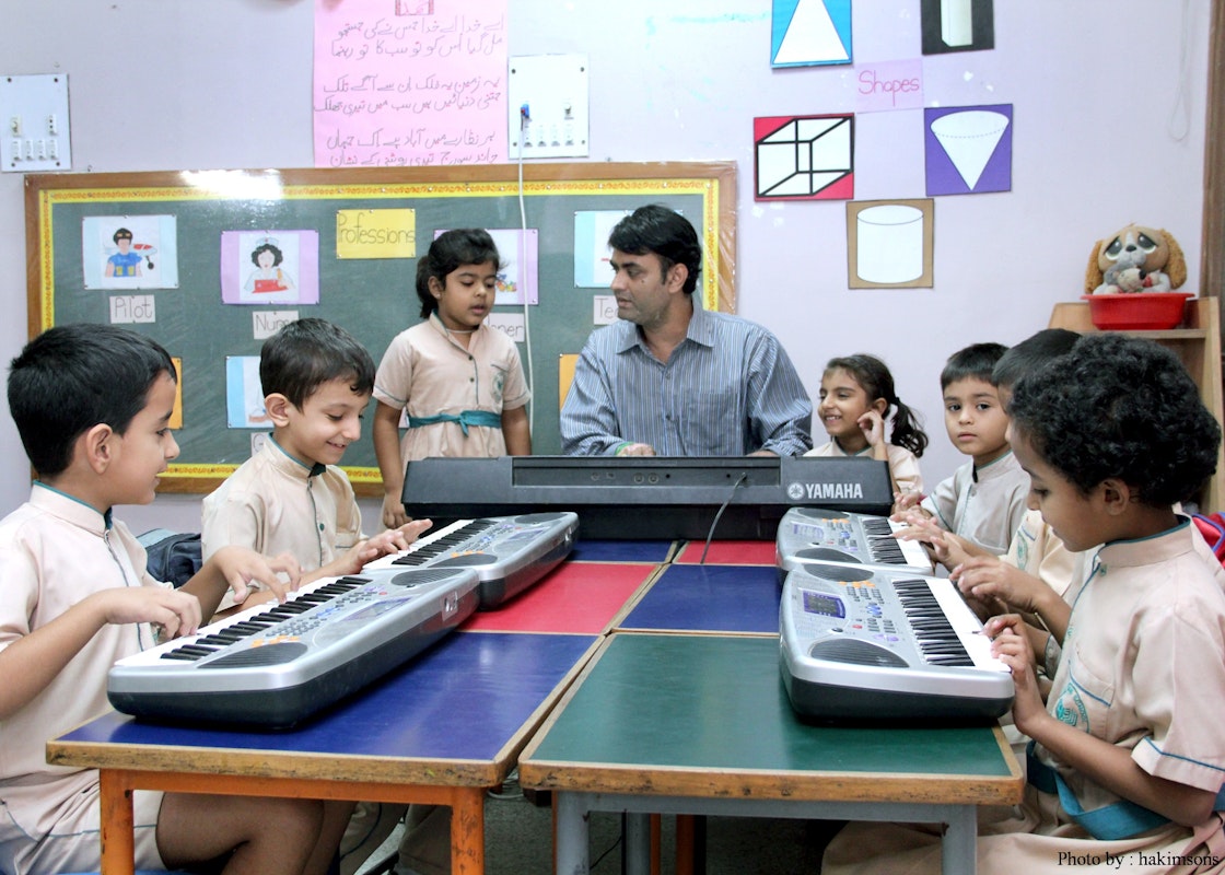 Children learning the piano at the Sultan Mohamed Shah Aga Khan School in Karachi. Courtesy of SMS, AKS