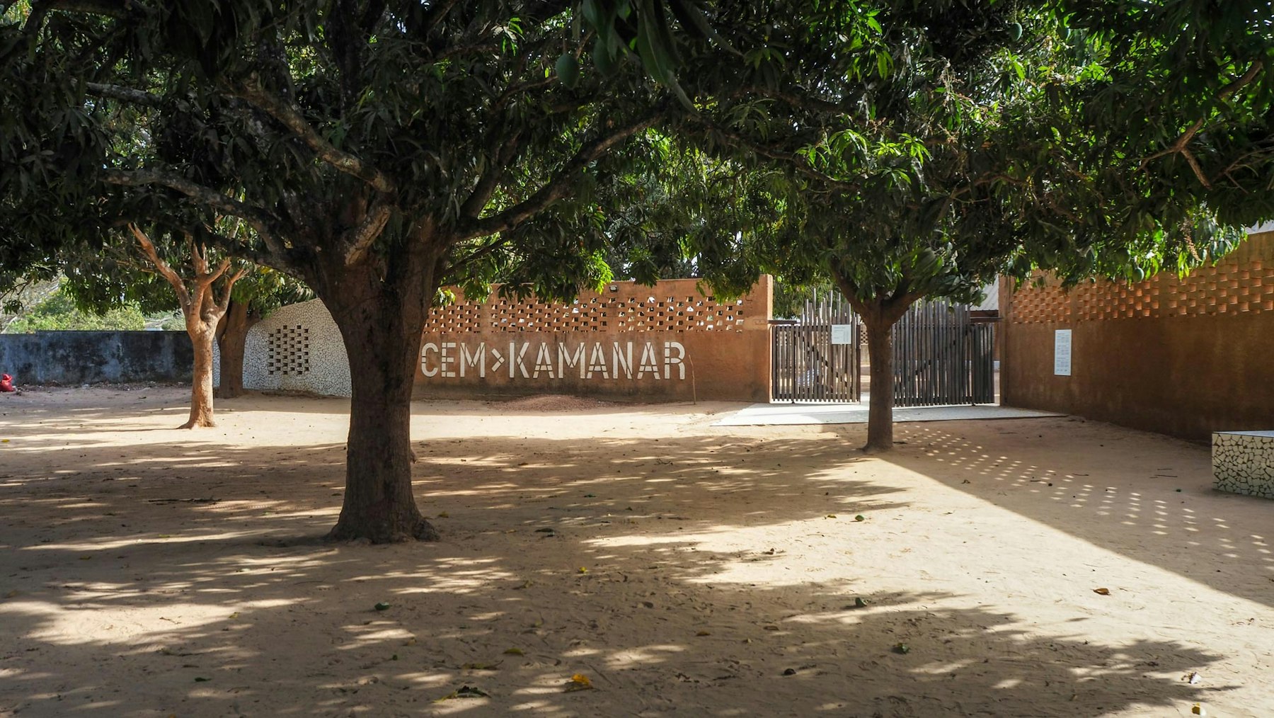 The modules are arranged in year-group classroom sets around squares and existing trees. | Aga Khan Trust for Culture / Amir Anoushfar (photographer)
