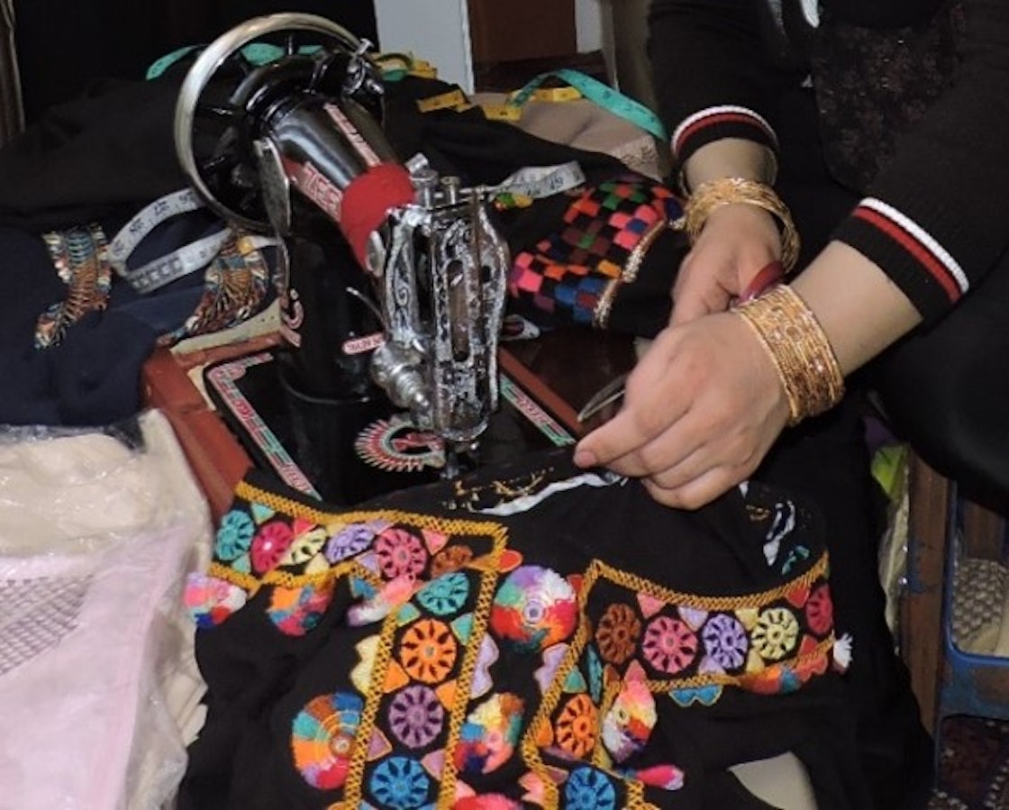 A woman from Kabul used her loan to purchase the raw materials for dresses, and has now hired 11 women for her expanding business.