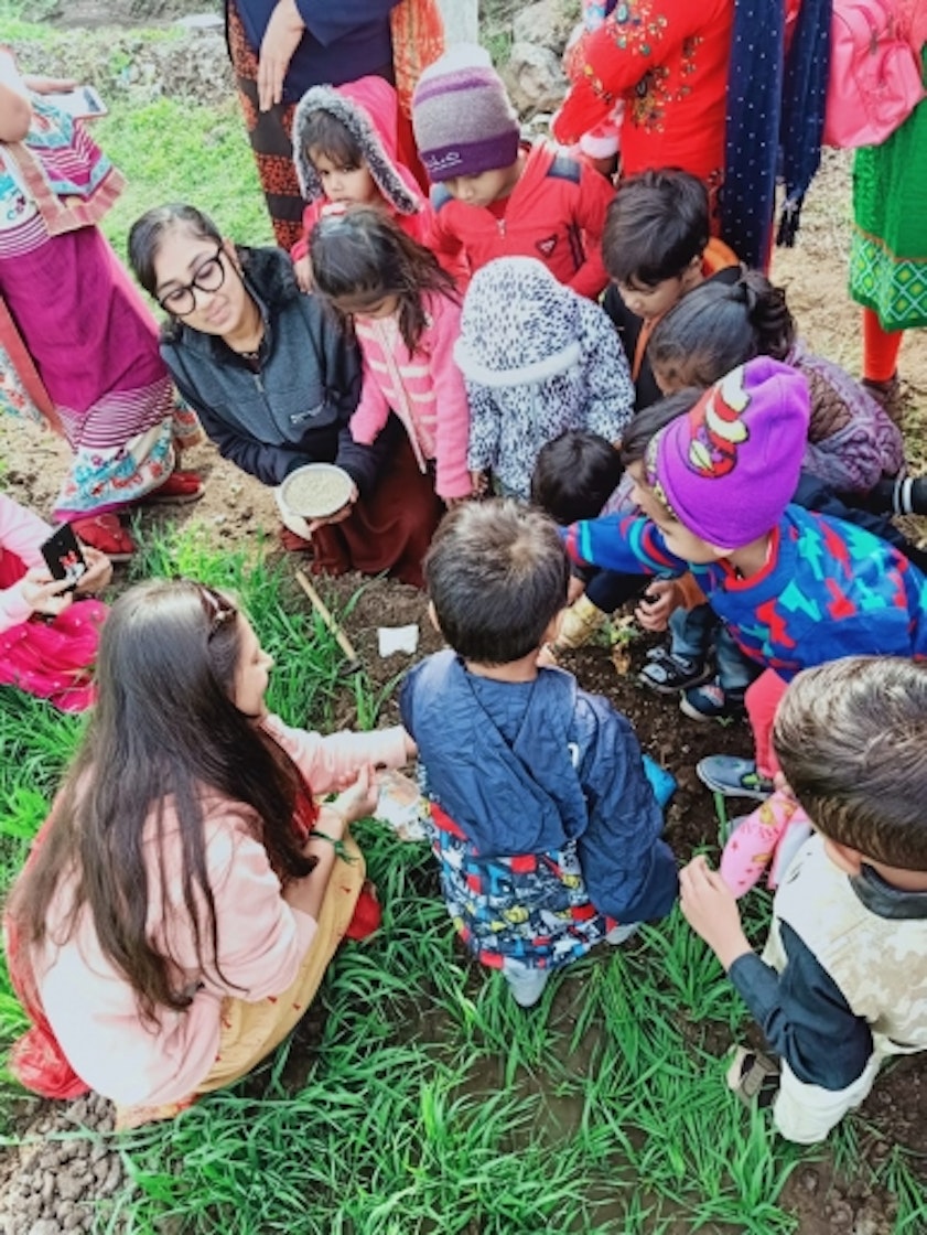 Students and teachers at the Aga Khan Preschool, Thorala, connect with nature by sowing wheat seeds.