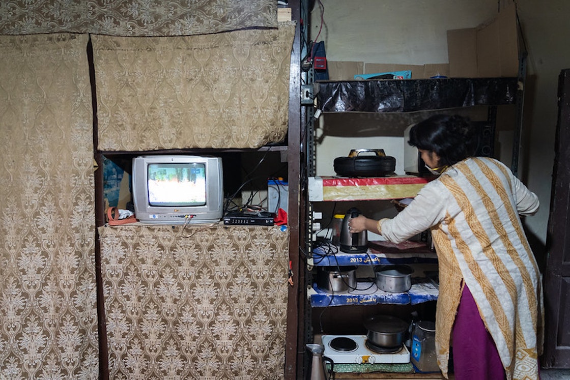 Access to electricity has benefitted children and women especially; here a woman uses home appliances powered by micro hydropower.