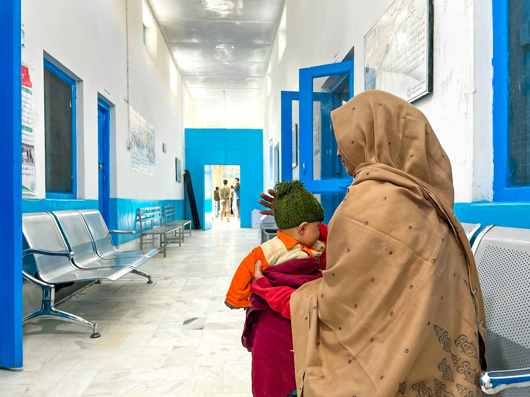 A mother and her young child, waiting to use the facilities at the health centre in Mehdiabad, Kharmang.