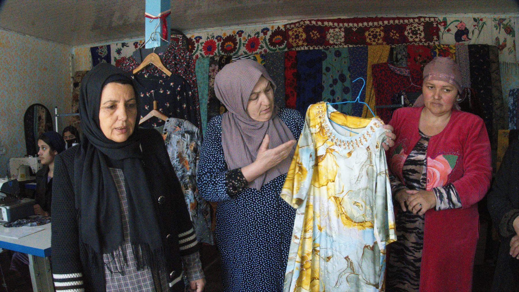Zebo Qalandarova (centre) displays her sewing.
